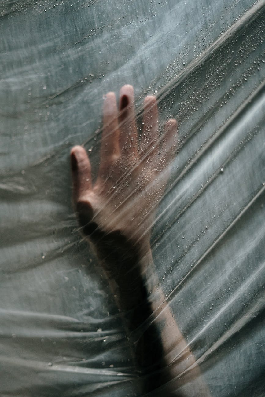 persons hand holding plastic