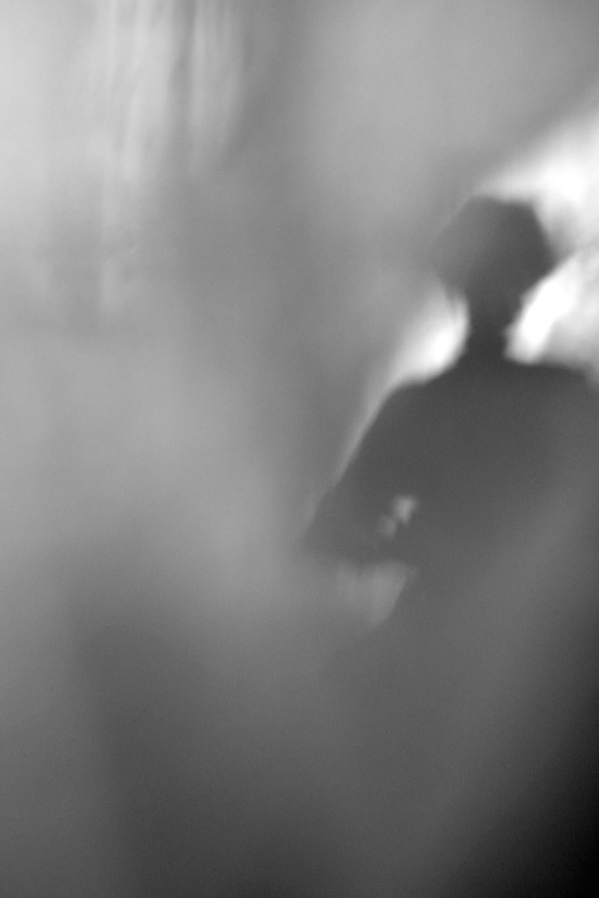 black and white photo of a shadow of a person on a wall
